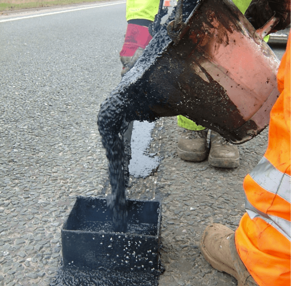 screeding material into a crack repair Road crack and joints repaired with Jointmaster BBA HAPAS approved system from Rhino Asphalt Solutions