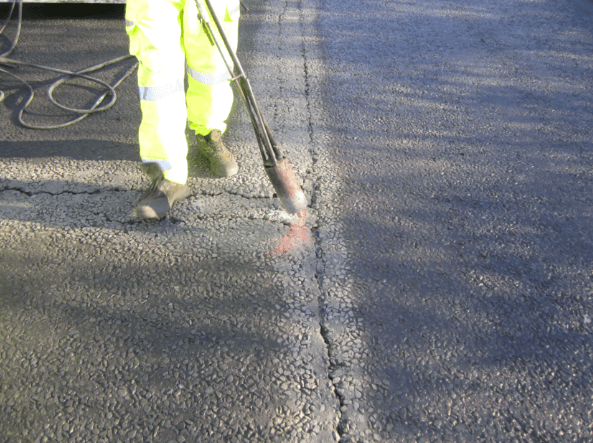cleaning and drying the Overband and fill and overband for Road crack and joints repaired with Jointmaster BBA HAPAS approved system from Rhino Asphalt Solutions